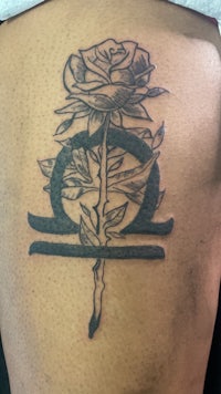 a tattoo of a rose on the back of a man