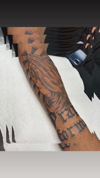 a black and white tattoo on a person's forearm